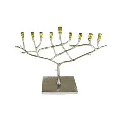 a silver and gold menorah is shown on a white surface with candles in it