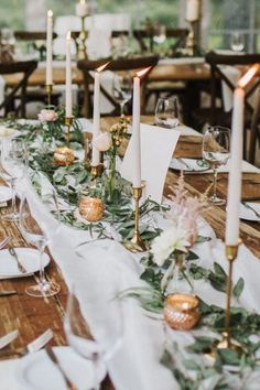 a long table is set with candles and place settings for an elegant dinner or party