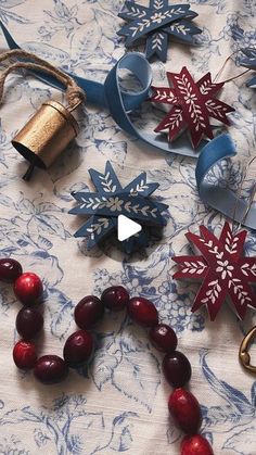 some paper snowflakes are laying on a table with other ornaments and decorations around them