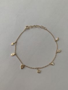 "This dainty yet sturdy charming charm bracelet is the perfect bracelet to layer with other bracelets or just to wear by itself. * 14K Yellow Gold * Approx. Diamond Weight: 0.07cts * Adjustable length: 6\"-7\" *Necklace also available: https://www.etsy.com/listing/510314824/14k-gold-tiny-charm-necklace Upgrades for FedEx/UPS guaranteed 2-day delivery are available and can be selected prior to checkout without separate invoicing. It is generally not an issue, but the USPS cannot guarantee deliver Minimal Charm Bracelet, Bracelet Charms Gold, Cute Everyday Bracelets, Bracelet Dainty, Charm Bracelet Dainty, Gold Bracelet With Charms, Gold Charms For Bracelets, Aesthetic Gold Bracelets, Gold Dainty Charm Bracelet