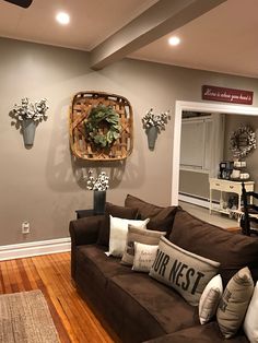 a living room filled with furniture and decor on top of a hard wood floored floor