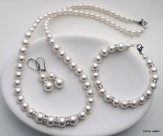 "This vintage inspired set comes with necklace, bracelet and earrings.  Swarovski pearls in your color of preference.  Makes a perfect gift for bridesmaids, maid of honor, mother of the bride or just for someone special! If you need a different color pearl contact me to check availability.  Perfect for any classy bride! Necklace, This classic and elegant necklace has graduated Swarovski pearls in ivory. Pearls in the front of the necklace measure 10 mm and are separated with rhinestone roundelle Classy Bride, Bridal Jewelry Pearl Sets, Pearl Bridesmaid Jewelry, Bridal Jewelry Sets Brides, Pearl Jewelry Set, Bride Necklace, Pearls Jewelry, Bridal Jewelry Set, Pearl Jewelry Sets