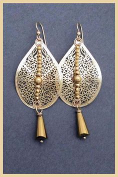 These long swingy earrings add romantic glam to any outfit. Gold tone filigree teardrop dangles and sparkly golden crystals are topped with 14k gold filled ear wires. Perfect to wear with a wedding guest outfit or to sparkle up your favorite party dress. Mix and match with gold tone jewelry to Bohemian Teardrop Earrings For Parties, Gold Teardrop Pendant Earrings For Party, Elegant Gold Long Drop Chandelier Earrings, Gold Chandelier Earrings With Dangling Beads For Evening, Gold Teardrop Dangle Earrings, Elegant Brass Chandelier Earrings For Celebration, Elegant Gold Teardrop Earrings For Festive Occasions, Elegant Festive Teardrop Earrings, Gold Teardrop Dangle Earrings For Party