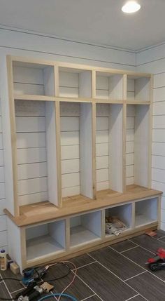 a room with some shelves and tools on the floor