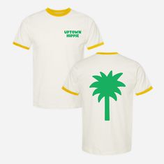 Embrace the beach vibes with our 100% cotton Palm Tree Ringer Tee! Featuring a vibrant green palm tree perfect for capturing the essence of laid-back island living. Product Details 100% Ring-Spun Cotton Natural and Yellow Made with Love Size + Fit Unisex Fits true to size Female model in the studio is 5'6 and wearing size S Female model on the beach is 5'6 and wearing size M Male model is 5'10 and wearing size L Summer Cotton T-shirt With Palm Tree Print, Cotton T-shirt With Tropical Print, Cotton Tropical Print T-shirt, Casual Tops With Tropical Print For Poolside, Casual Tropical Print Tops For Poolside, Tropical Cotton T-shirt With Palm Tree Print, Spring Tropical T-shirt With Palm Tree Print, Tropical Palm Tree Print T-shirt For Spring, Cotton T-shirt With Palm Tree Print In Relaxed Fit