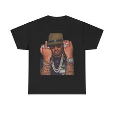 a black t - shirt with the image of a man wearing sunglasses and a hat