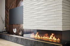 a modern fireplace in a living room with white brick wall and wood paneling on the side