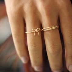 Our Dainty Bow Ring, is the perfect trendy yet timeless tiny gold ring to add to your collection. The perfect stackable ring, our Ribbon ring is handmade with a delicate twist rope style band and is available in either 14k Gold Fill and Sterling Silver coming soon! ∙ Gift Ready in a jewelry box! ∙ Handmade in Vancouver, Canada.  ∙ 100% 14k Gold Fill (and Sterling Silver coming soon!) --------------------------------- M E A S U R E M E N T :  Width: 1.3mm Bow: approx. 10x10mm (please note the bow Dainty Adjustable Midi Rings For Promise, Dainty Tiny Initial Ring, Dainty Rose Gold Initial Ring, Rose Gold Plated Midi Rings For Wedding, Dainty Gold Plated Midi Rings For Wedding, Dainty Initial Promise Ring, Dainty Rose Gold Midi Rings As Gift, Adjustable Dainty Midi Rings, Gold Dainty Initial Ring With Simple Design