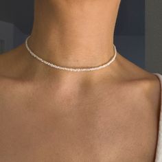 STERLING SILVER PEARL CHOKER NECKLACE  This sterling silver pearl choker necklace embodies the essence of coquette minimalist jewelry. The beaded dainty choker offers a delicate touch, making it a versatile accessory for any occasion. Its elegant simplicity makes it a perfect mother-daughter simple gift, adding a subtle yet stylish element to everyday wear. ✔️ Material: Sterling silver and 1-2 mm  freshwater pearl ✔️ Length: from 14'' to 18'' (36- 46 cm)  ✔️ Hypoallergenic  ✔️Handcrafted in USA Necklace Coquette, Dainty Choker, Simple Gift, Best Gifts For Her, Pearl Choker Necklace, Pearl Collection, White Jewelry, Simple Gifts, Pearl Choker