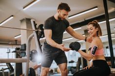 a man and woman working out in the gym