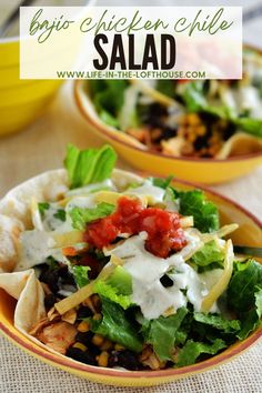 two bowls filled with taco salad on top of a table next to a yellow bowl