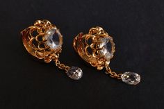 1900s Straits Chinese earrings set with moonstones and diamonds in 20k. These part-hoop, part-stud earrings are emblematic of Anglophiles in this region. A strong East-West look, these earrings in other parts of the world is sometimes called an 'oriental' style. The juxtaposition in a simple thing - turning a common pair of ear studs into a cross between hoops and studs with a tail curtsy - this works amazingly. These are flawless moonstones with a bold blue flash, yet a turn of the head the blu Antique Jeweled Earrings For Formal Occasions, Antique Jeweled Formal Earrings, Vintage Gold Earrings With Rose Cut Diamonds, Antique Gold Jeweled Earrings, Brass Wedding Earrings With 17 Jewels, Elegant Ceremonial Jeweled Earrings, Victorian Jeweled Gold Earrings, Ornate Gold Earrings With Rose Cut Diamonds, Victorian Jeweled Earrings For Formal Occasions