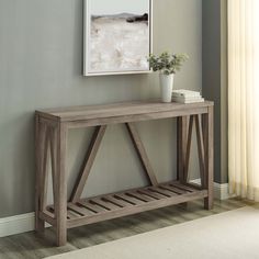 a wooden console table with a plant on top