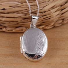 This is solid 925 sterling silver oval shape photo picture locket pendant.   925 stamped.    The locket is engraved on the front side and plain highly polished on the back.     Approx. pendant measures:            total length: 35mm           without bail: 26mm           width: 20mm    Approx. pendant only weight: 5.7gr.  Available on its own or with various length (16-30Inch) 1mm curb chain, please choose from the drop-down menu at the top of the page. Both locket pendant and chain are solid st Silver Oval Pendant Necklace With Engraving Option, Silver Oval Pendant Necklaces With Engraving Option, Silver Sterling Locket Necklace With Engraving Option, Silver Oval Pendant Jewelry With Engraving Option, Engraved Silver Oval Jewelry, Silver Oval Engraved Jewelry, Silver Engraved Oval Jewelry, Elegant Round Pendant Locket Necklace Stamped 925, Sterling Silver Locket Necklace With Oval Link For Gifts