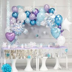 a table topped with balloons and snowflakes