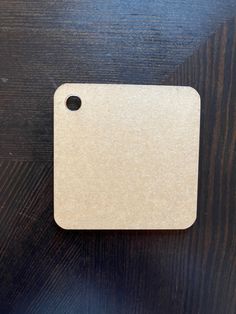 a white tag on top of a wooden table