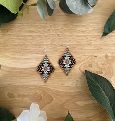 These gorgeous hand made earrings are black, brown, light blue, and white with silver hooks. They are extremely light weight and comfortable for all day wear. They are 2.5 inches long from the top of the hook to the bottom of the earring. Western Beaded Earrings, Aztec Earrings, Native Beading, Seed Bead Jewelry Patterns, Earrings Patterns, Beads Work, Beaded Earring, Brick Stitch Earrings, Handmade Earrings Beaded