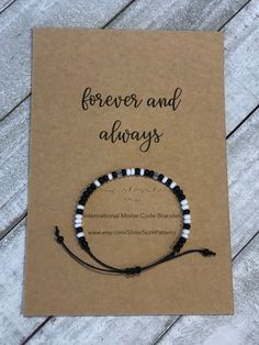 a card with a black and white beaded bracelet on it that says, forever and always