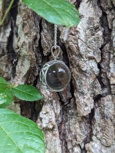 An extra large 20mm crystal clear quartz, tension set in a sterling silver, filigree, crescent moon shaped pendant.   The pendant is polished to a bright, shiny finish. Arrives with the pictured, 24 inch sterling silver rolo chain.  The 8th picture shows the filigree back of the mount. The chain shown is the chain that is included.   There has been no drilling or marring of the quartz whatsoever. The whole quartz sphere is what gives the piece its authenticity. Undrilled whole orbs are the hallm Quartz Sphere, Sterling Silver Filigree, Moon Shapes, Clear Quartz Crystal, Rolo Chain, Silver Filigree, Quartz Pendant, Quartz Necklace, Crescent Moon