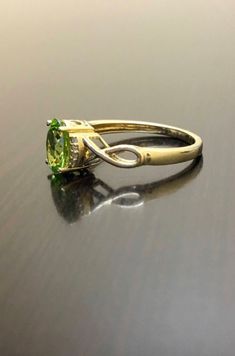 DeKara Designs Collection Metal- 14K Yellow Gold, .583. Stones- Natural Oval Peridot 8 MM x 6 MM, 8 Round Diamonds G-H Color VS2 Clarity 0.10 Carats. Size-3-12. Beautifully Handmade Art Deco Inspired Diamond Peridot Engagement Ring Made in 14K Yellow Gold. The ring has a high quality beautiful and fiery oval shaped peridot that is professionally set in between four prongs. There are four fiery professionally prong set round diamonds on each side of the peridot. Please allow 3-7 working days for Peridot Wedding Ring, Peridot Engagement Ring, Peridot Engagement Rings, Art Deco Gold, Gold Diamond Ring, Peridot Ring, Art Deco Engagement Ring, Art Deco Inspired, Diamond Wedding Rings