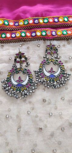 If you are into boho and hippie pieces of jewellery, then having a pair of boho tribal earrings is inescapable! Vastrabhushan brings you a combination of Afghani and Indian- designed Afghani boho earrings available in multicolours to compliment and add jazziness to your outfit. The rarely found mirror earrings are made of real stained-glass and handcrafted with the finest materials, specially designed to suit both traditional and modern attires. To retain your jewellery's shine for a long time, Handmade Colorful Earrings For Festival, Colorful Handmade Earrings For Festivals, Handmade Colorful Festival Earrings, Traditional Colorful Festival Earrings, Bohemian Festive Plug Earrings With Latkans, Multicolor Chandbali Earrings For Festival, Handmade Multicolor Festive Earrings, Colorful Traditional Earrings, Multicolor Earrings As Festival Gift