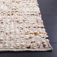 an area rug is shown on the floor, with white and brown colors in it