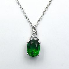 A fantastic jewelry piece to make your mother's neckline stylish.  In this gleaming Silver pendant, a brilliantly oval cut precious emerald birthstone, as shown, includes 3 round cut dazzling Cubic Zirconia. This luxurious glowing emerald centerpiece weighs 2.95 carats, measures 9x7 mm, and is an excellent prong set. Surely this elegant minimalist pendant will be a symbol of unconditional love. Birthstone Emerald Necklace Silver May birthstone jewelry Oval cut pendant Trendy Best Friend Gift Sentimental Promise Pendant casual, typical, simple, handmade pieces vintage, elegant design, Minimalistic Minimalist pendant chain Minimal Delicate cute jewelry pieces keychain pendant for her gift Necklace promise Pendant necklace for women very small classic pendant necklace unfussy jewelry design s Power Jewelry, Classic Pendant Necklace, Tiny Heart Necklace, Jewelry Promotion, Emerald Birthstone, Minimalist Pendant, Jewelry Board, Minimal Necklace, Gemstone Pendants