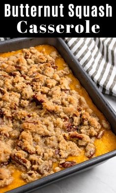 a casserole dish with butternut squash and crumbled topping on top