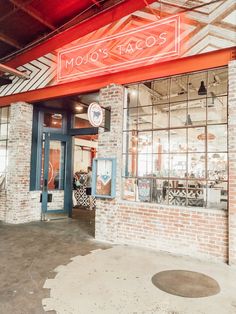 the front entrance to molos tacos, which is located in an old brick building