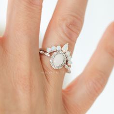 The Beautiful Dreamer ring is inspired by the 1864 song called "Beautiful Dreamer." The alternating marquise and round stone halo design is reminiscent of the graceful curves of a flower blooming. The ring has a dreamy and ethereal aesthetic, but is also classic and timeless. White Pear-shaped Ring With Halo Design, White Pear-shaped Halo Design Ring, White Cluster Jewelry With Halo, White Marquise Cut Promise Halo Ring, Elegant White Stackable Rings With Rose Cut Diamonds, White Heirloom Cluster Ring With Halo Design, Heirloom White Halo Ring With Rose Cut Diamonds, Heirloom White Cluster Ring With Halo Design, White Marquise Cut Halo Design Jewelry