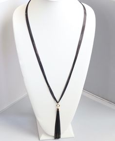 This necklace is the perfect accessory for any occasion. It's made of black rope and has a black tassel. The black color is perfect for any outfit, and the tassel adds a bit of personality. Elegant 16 Inch Snake Chain Necklace, Formal Adjustable Multi-strand Necklace, Elegant Metal Tassel Necklace, Elegant 16 Inch Party Chain Necklace, Adjustable Clavicle Chain Jewelry For Evening, Elegant Snake Chain Choker, Elegant Black Formal Choker, Black Pendant Necklace With Chain, Adjustable Snake Chain Elegant Choker