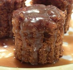 three pieces of chocolate cake sitting on top of a white and yellow plate with caramel drizzle