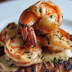 grilled shrimp and praw on top of meat