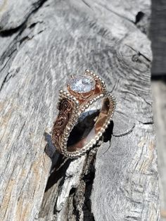 a ring sitting on top of a piece of wood