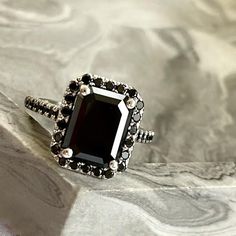 a black diamond ring sitting on top of a table