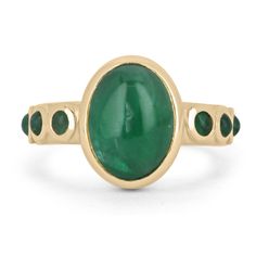 Featured is a stunning natural emerald cabochon unisex ring. This one-of-a-kind piece features a large 4.54-carat oval cut emerald cabochon as the center stone. It displays many good qualities and a lush medium-dark green color. Accenting the center stone are petite, round cut emerald cabochons on both sides of the shank. All gemstones are bezel set in a gleaming 14K yellow gold setting.  Setting Style: Bezel Setting Material: 14K Yellow Gold Gold Weight: 6.2 Grams Main Stone: Emerald Cut: Cabochon Shape: Oval Cut Weight: 4.54-Carats Clarity: Translucent Color: Green Luster: Very Good Treatments: Natural, Oiling Origin: Zambia Secondary Stone: Emerald Cut: Cabochon Shape: Round Cut Weight: 0.48-Carats (Total) Clarity: Translucent Color: Green Luster: Very Good Treatments: Natural, Oiling O Yellow Gold Emerald Ring Oval Cabochon, Yellow Gold Emerald Ring With Oval Cabochon, Heirloom Oval Cabochon Emerald Ring, Emerald Bezel Set Oval Cabochon Ring, Green Emerald Ring With Oval Cabochon Bezel Setting, Cabochon Emerald Ring Gift, Gift Cabochon Emerald Ring, Emerald Oval Cabochon Gemstone Rings, Oval Cabochon Emerald Ring For May Birthstone