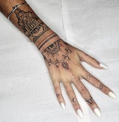 a person's hand with tattoos on it and a ring around the wrist,