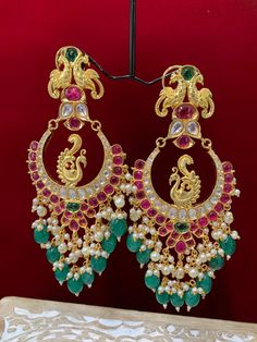 Premium quality High gold plated, pearl work, hand carved work , AD lining and kundan work. Clip back.  about 5.5 inch long  Absolute designer piece and statement earring. Luxury Kundan Danglers For Ceremonial Occasions, Luxury Green Chandbali Earrings, Luxury Multi-stone Chandbali Earrings, Luxury Ornate Chandbali Bridal Earrings, Luxury Kundan Chandbali Chandelier Earrings, Luxury Green Chandbalis With Tilla Detail, Luxury Green Chandbali Jhumkas, Luxury Cutdana Chandbalis For Festive Occasions, Luxury Festive Chandbalis With Peacock Design