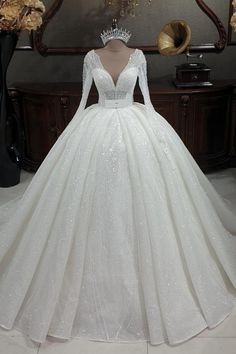 a white wedding dress on display in front of a mirror