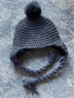 "Soft and snuggly charcoal gray earflap hat with gray pompon and ties  So adorable for Christmas and the entire winter!  This hat is extra warm and snuggly because it has a black fleece lining!  So-o-o-o-o comfy Lovely personally-designed and crafted \"crochet baby hat\". All acrylic yarn in \"Gray and Black\" has been used. Perfect for Christmas gifts or any occasion. This is great for any of baby's outings or riding in the car seat or stroller.  It is available in all sizes up to an adult size Beautiful Baby Blanket, Black Fleece, Black Hat, Baby Head, Christmas Hat, Crochet Baby Hats, Ball Cap, Cool Patterns, Baby Hats