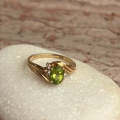 a green ring sitting on top of a rock