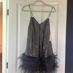 Adorable Feathered Sequin Mini Dress! Great For A Fun Night Out! Chic Sequined Dress For Costume Party, Glamorous Feather Trim Dress For Date Night, Glamorous Dresses With Feather Trim For Date Night, Glamorous Date Night Dress With Feather Trim, Summer Evening Dress With Feather Trim, Glamorous Feathered Cocktail Dress, Party Season Dresses With Feather Trim, Sleeveless Feather Dress For Night Out, Party Season Feather Trim Evening Dress