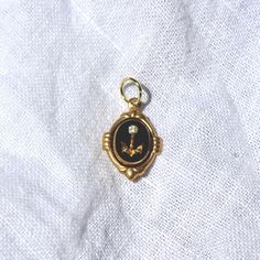 This charm is made of an 10x8mm carved glass cab that was produced in Germany in the 1970s. The charm has been hand set by me in a raw brass setting. The overall size of the charm including the setting is 18mm tall (including loop) and 12mm wide. The charm comes with a jump ring for threading on your favorite necklace Vintage Enamel Jewelry With Vintage Charm, Brass Oval Pendant Jewelry With Charms, Oval Pendant Charms Jewelry In Brass, Antique Brass Charms For Collectors, Antique Yellow Gold Brass Charms, Victorian Vintage Charm In Yellow Gold, Vintage Engraved Brass Charms, Victorian Yellow Gold Vintage Charm, Vintage Yellow Gold Charms For Gift