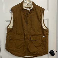 Lee Workwear Canvas Vest, Sherpa Lined For Warmth. Size Large. 3 Outer Pockets, One Inner Pocket Utility Vest For Outdoor Work In Fall, Fall Utility Vest For Outdoor Work, Casual Vest For Outdoor Work In Fall, Brown Outerwear With Pockets For Outdoor Work, Brown Utility Vest For Fall, Outdoor Work Vest With Pockets For Fall, Winter Utility Vest For Outdoor Work, Winter Cotton Vest With Multiple Pockets, Workwear Vest