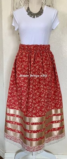 "Traditional Ribbon Skirt red, beige prairie floral print, accented with beige satin and ivory lace ribbon.  Finished with elevated  details and lovingly made by hand. A paper bag waist hugs the body, while also being comfortable to wear. See our sizing details below to find your perfect size.  Ready to ship! A long time symbol femininity, sisterhood and solidarity, used in ceremony and everyday, every skirt tells a story written by the woman who wears it. Perfect for every season, dressed up or Native American Ribbon Skirts, Ribbon Skirts Pattern, Ribbon Skirts Native American, Crochet Ribbons, Time Symbol, Fancy Shawl Regalia, Ribbon Pants, Powwow Outfits, Ribbon Clothing