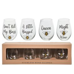 four stemless wine glasses in a box with the words queen, i love bees on them