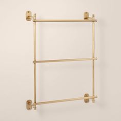 the brass towel rack has two bars on each side and is attached to the wall