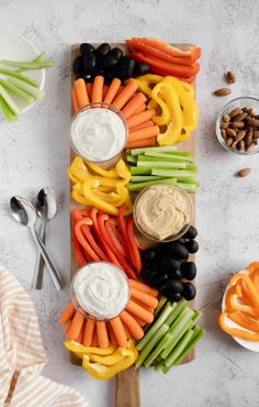 carrots, celery, black olives and other vegetables on a cutting board