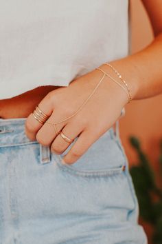 Channel your inner bohemian with this hand chain that loosely drapes around your finger and wrist. Whether you’re at a music festival or brunch with the girls, this hand candy turns any outfit into magic. Bracelet is 6" with a 1" extender. S/M: ring size 5-7.5, wrist size 6-7" M/L: ring size 8-10.5, wrist size 7-7.5" Available in 14kt Gold Fill + Sterling Silver. Handmade in Eau Claire, WI. Our jewelry is handmade so each piece will be unique and may vary slightly from what is pictured. Bohemian Body Jewelry With Adjustable Chain For Summer, Bohemian Spring Bracelet, Adjustable Chain Body Jewelry For Festivals, Gold Bracelets With Adjustable Chain For Festival, Dainty Summer Bracelets With Adjustable Chain, Dainty Summer Bracelet With Adjustable Chain, Hand Wrapped Bracelet Jewelry For Party, Trendy Adjustable Jewelry, Bohemian Hand Wrapped Bracelets For Party