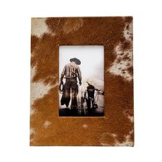 a cow print frame with a man and his bike